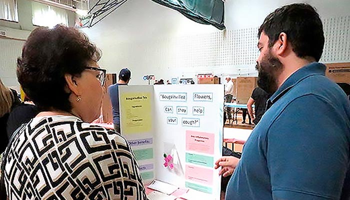 Chemistry student presenting his research project on bougainvillea tea at the Spring 2022 FIESTA Symposium Page Banner 