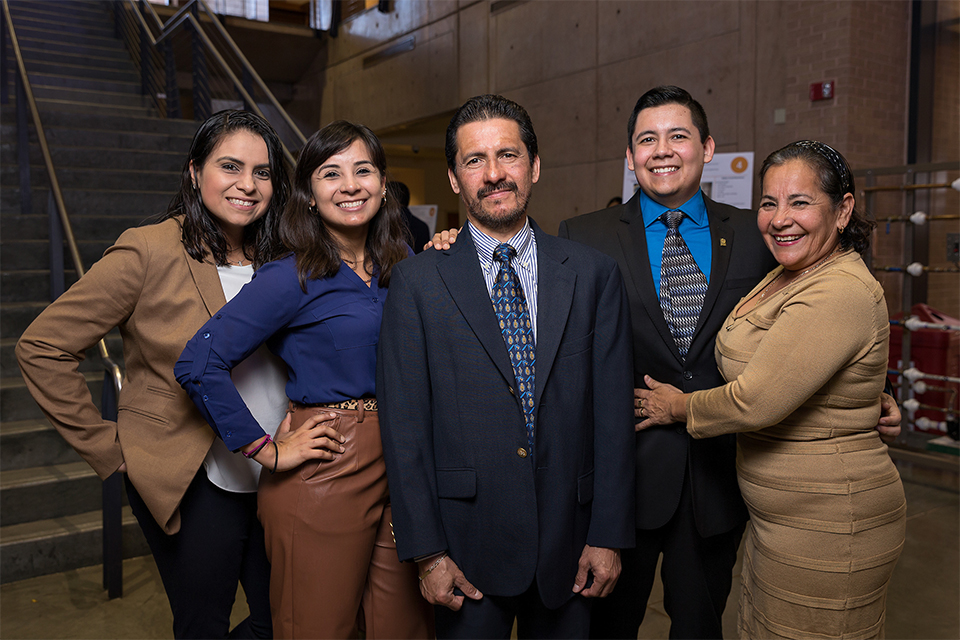 UTRGV manufacturing engineering grad student Francisco Torres Diaz (fourth from left), will accept his MSE during UTRGV commencement ceremonies Dec. 15 in McAllen. He says his family, shown here, was his strongest support system during the roughest of times. In the photo, from left, are family friend Berenice Martinez; his sister, Carmen Torres; his father, Francisco Rafael Torres Violante; Francisco; and his mother, Maria del Carmen Diaz Barrios. (UTRGV Photo by Paul Chouy)