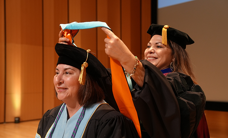 Spring 2024 doctoral candidate Dalila Ochoa is hooded by Dr. Joy Esquierdo, during the doctoral hooding ceremony, May 8, 2024, at UTRGV Performing Arts Center on the Edinburg Campus. (UTRGV Photo by Jesús Alférez)
