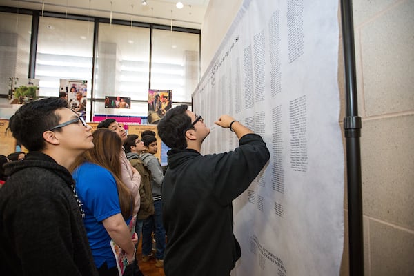 Guests read names of fallen at the exhibit