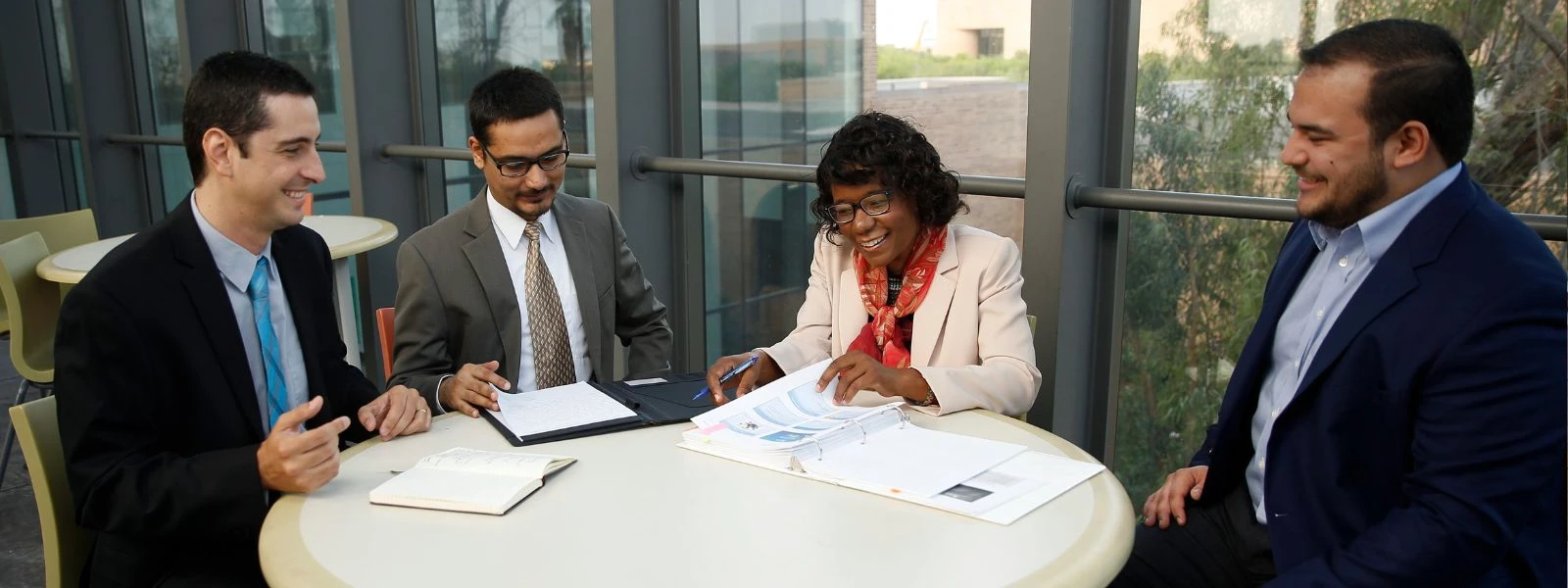 Business graduate students reviewing business documents