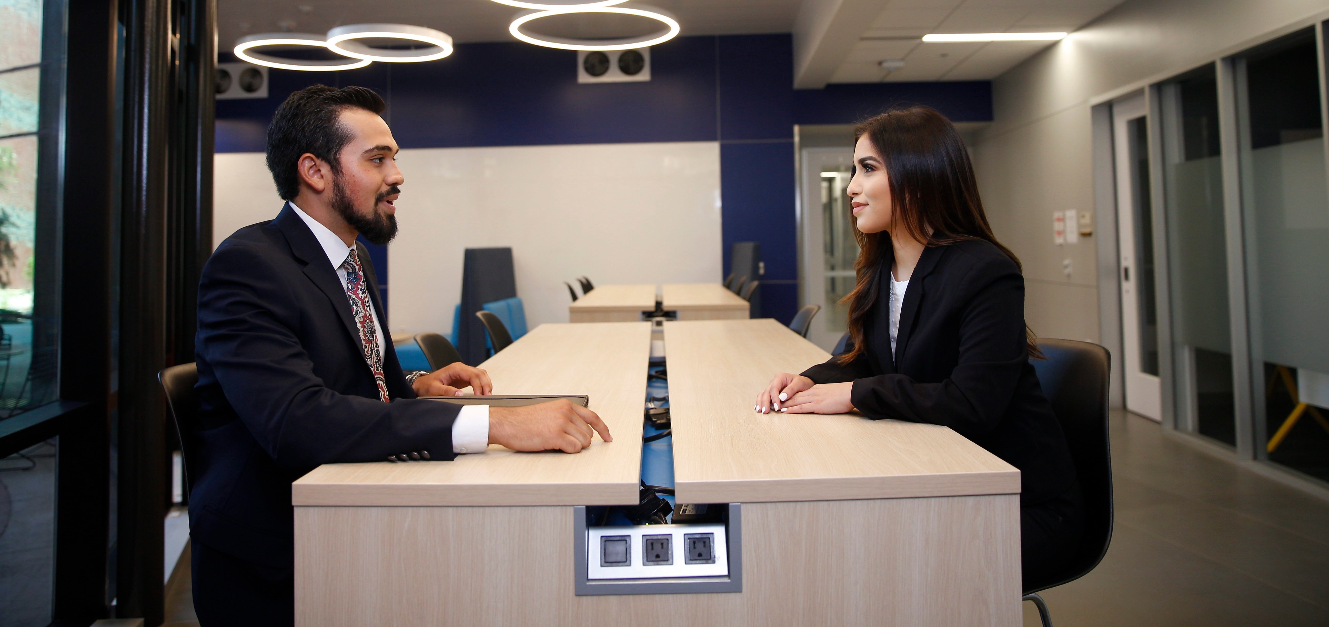 Two business people meet at a table