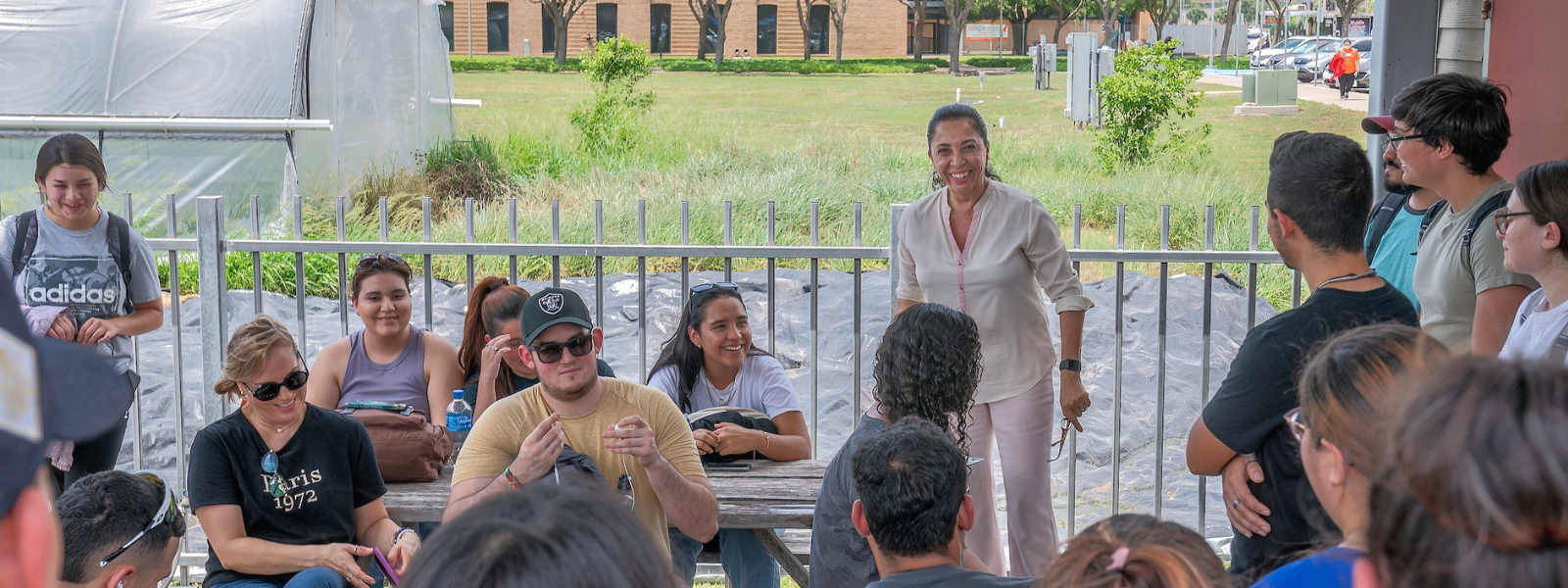 Students learning in outdoor setting with lecturer.