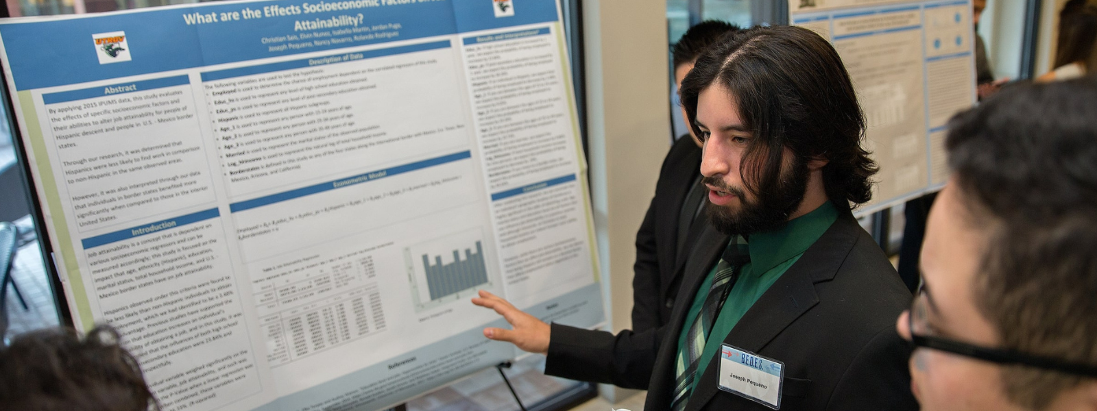 Doctorate student presenting project on poster board. 