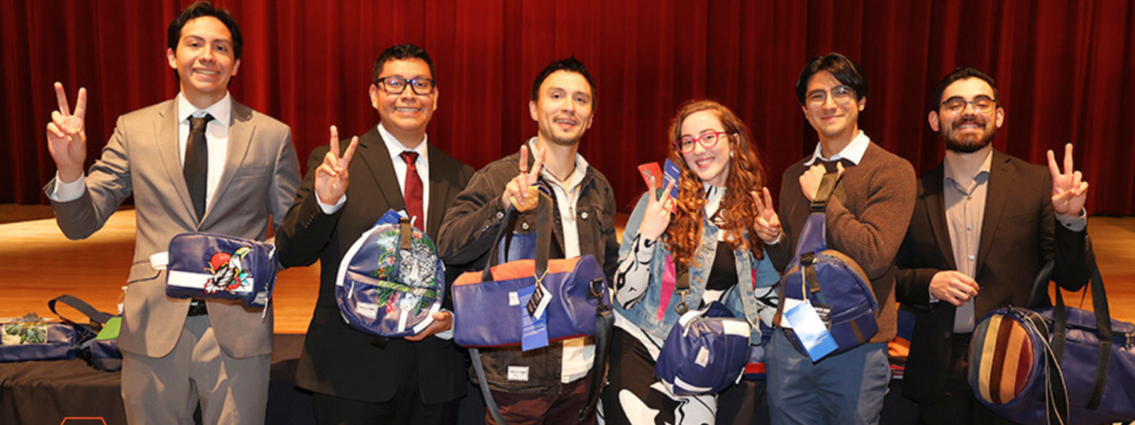 COBE students posing during event while holding UTRGV merch.