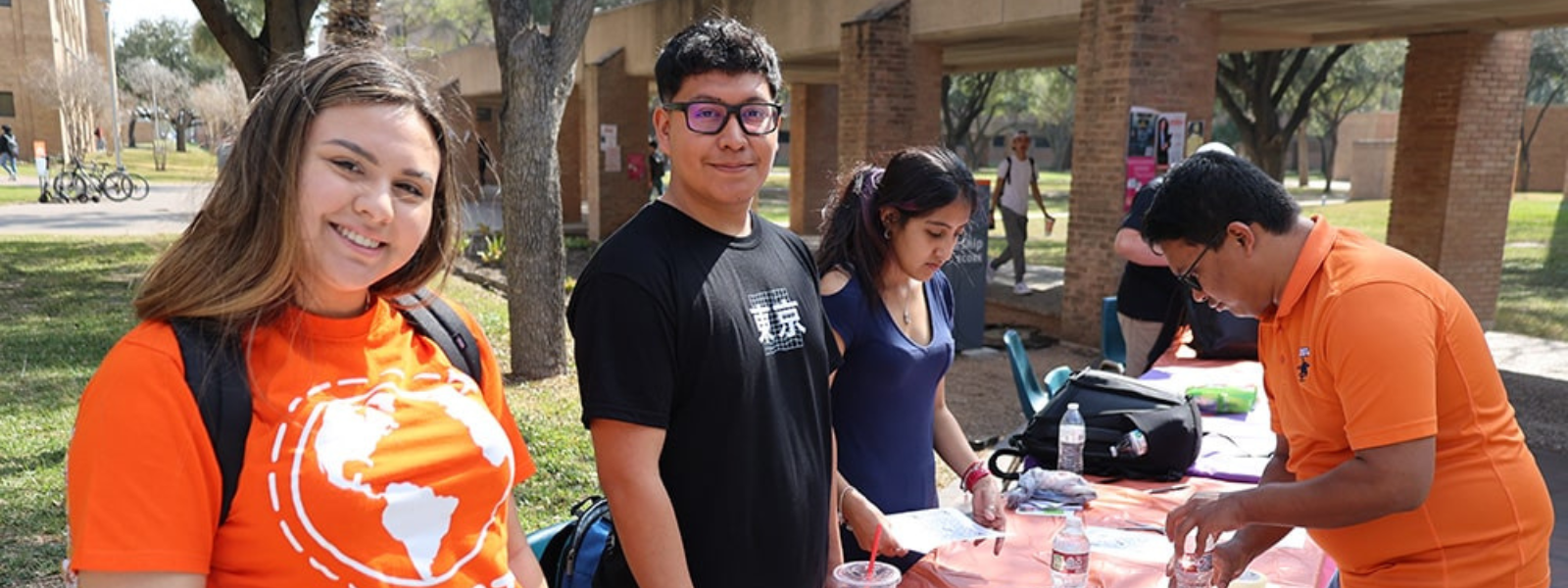 Students from UTRGV organization during event smiling at the camera.