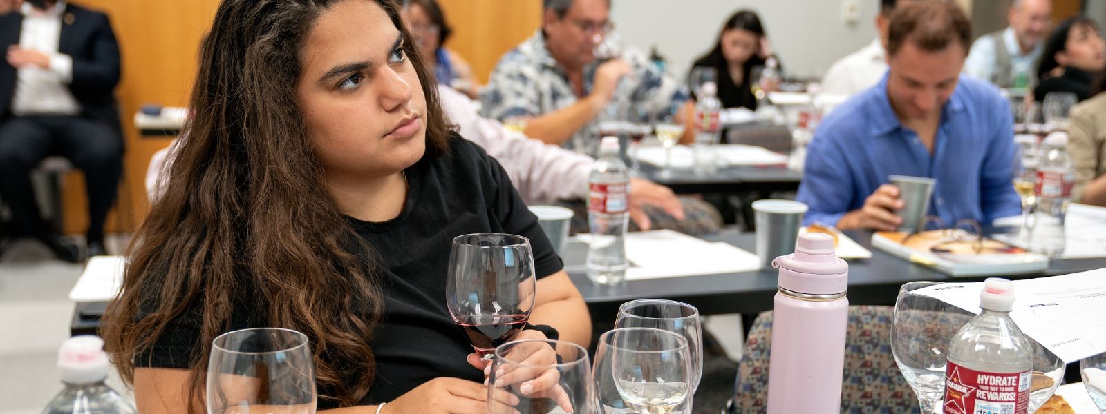 Hospitality and Tourism Management student learns about the major wine regions and beverages of the world during Introductory Sommelier Course and Examination.