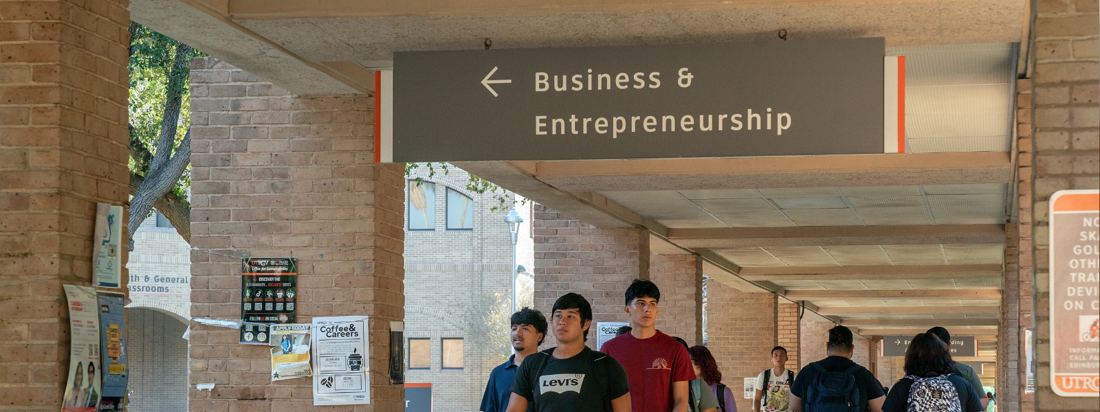 Students walk in front of RCVCOBE sign