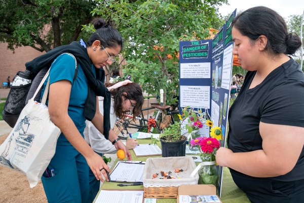 Mariah Lopez, Environmental Science student from Weslaco, talked with patrons about the Environmental Awareness Club at Earth Fest. (UTRGV Photo by Paul Chouy)